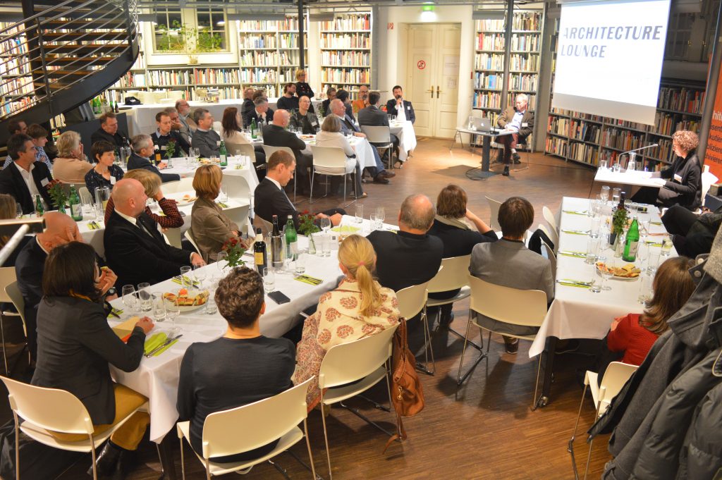 People sitting at tables engaged in conversation