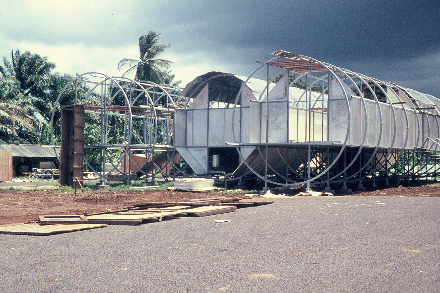 Photo of building site with palm trees in background