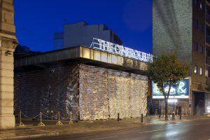 Night-time view of building with a golden curtain