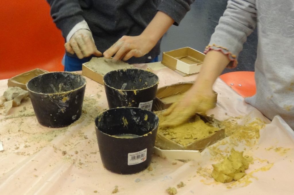 Two children working with clay.