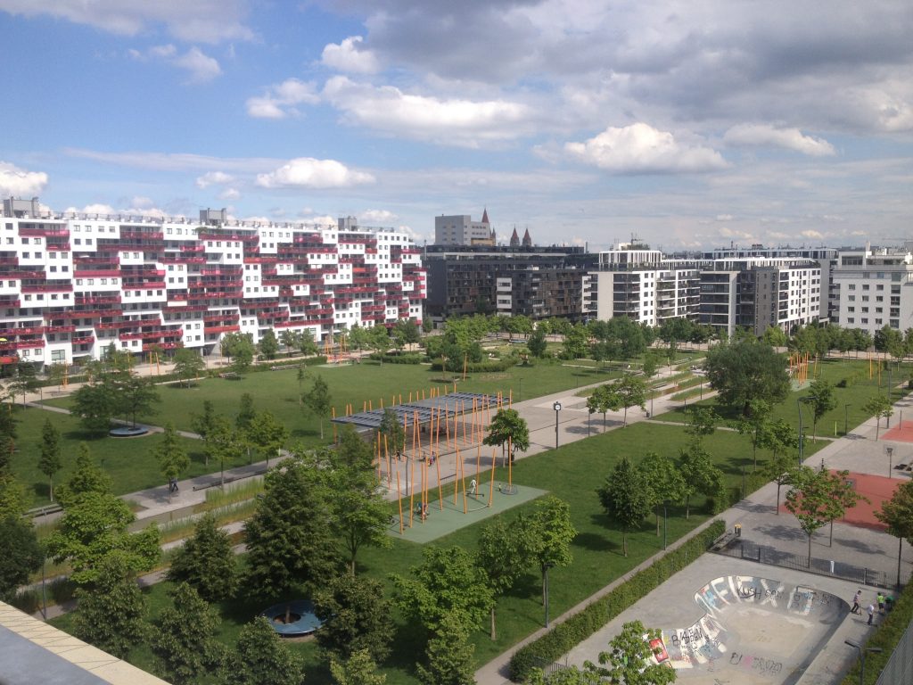 Large park lined by residential buildings