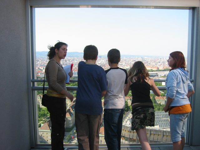 Group of school students looking at the city of Vienna from above