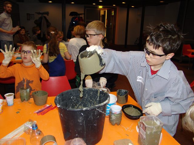 Children mixing concrete.