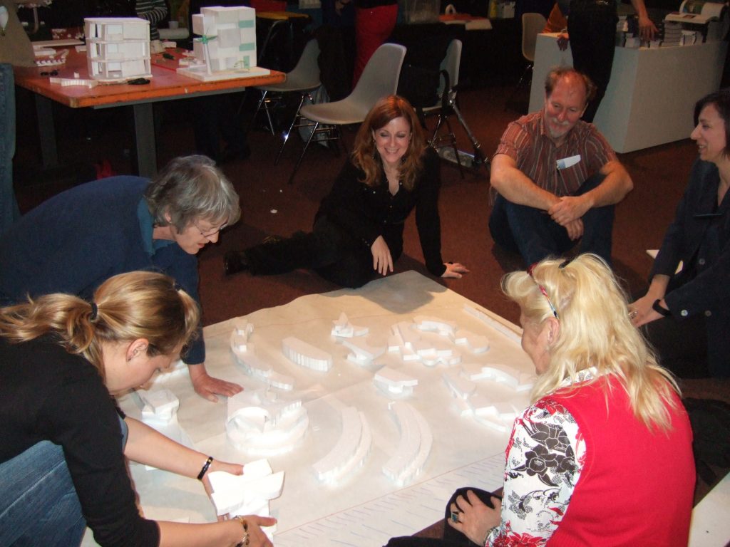 Participants in a workshop discuss their city model.