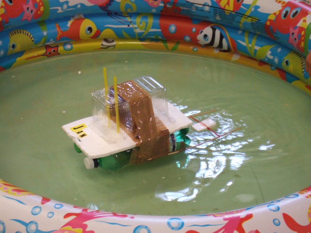 Model house floating in a small pool