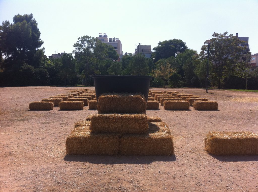 Bales of straw that have been positioned precisely in a field