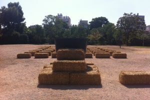 Bales of straw that have been positioned precisely in a field