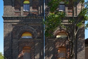 Sitzende Menschen auf Bänken mit Tischen im Hof beim Wasserturm vor der Nordbahn-Halle