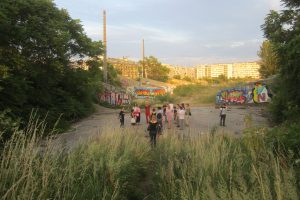 People walking through the overgrown landscape at Nordbahnhof