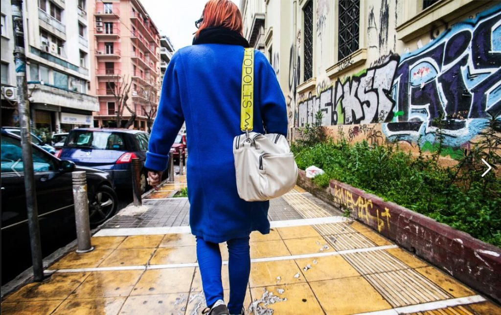 woman from behind with blue coat