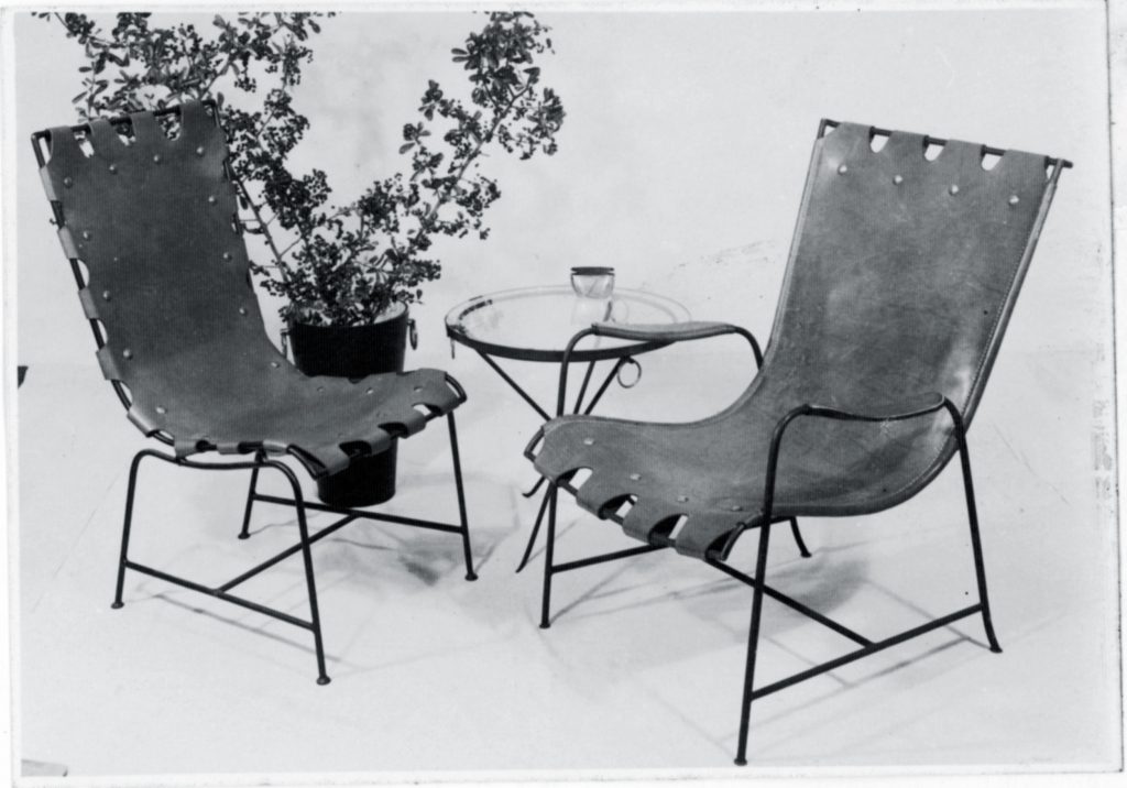 Two iron chairs with leather covering