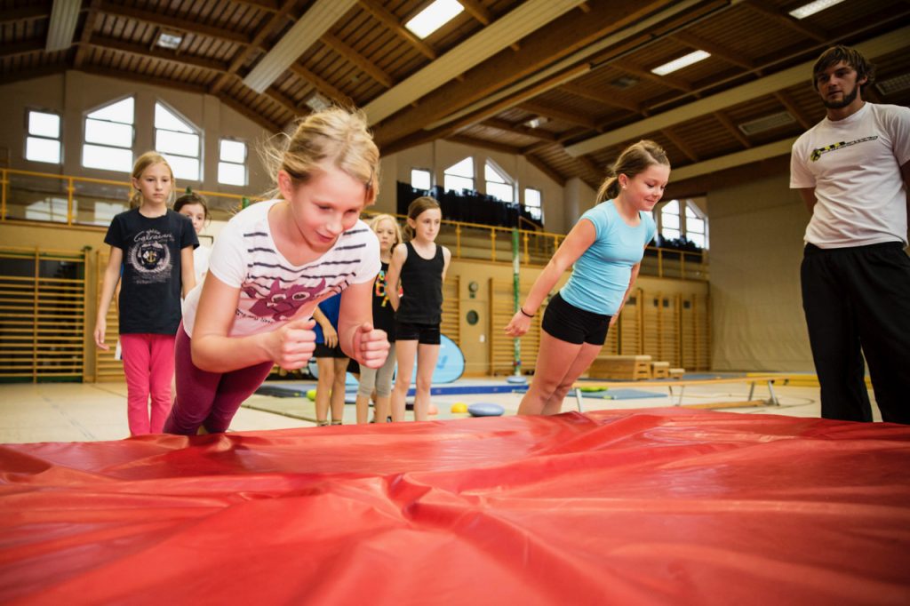 children falling onto mats