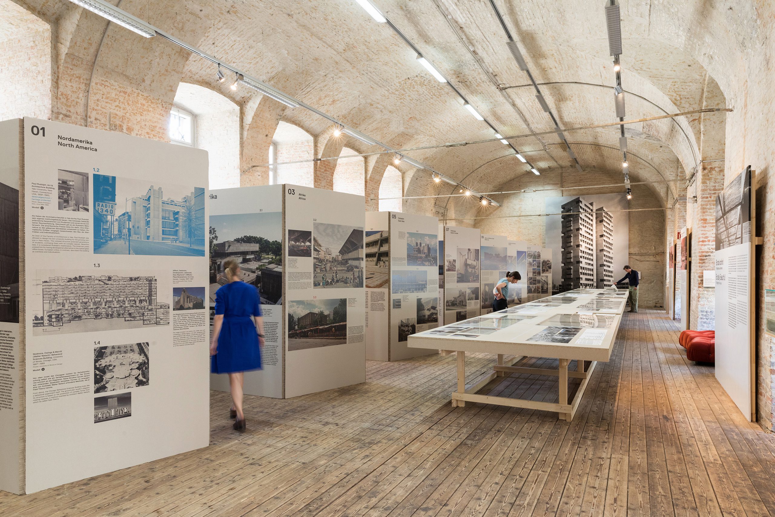 Woman in a blue dress going through an exhibition