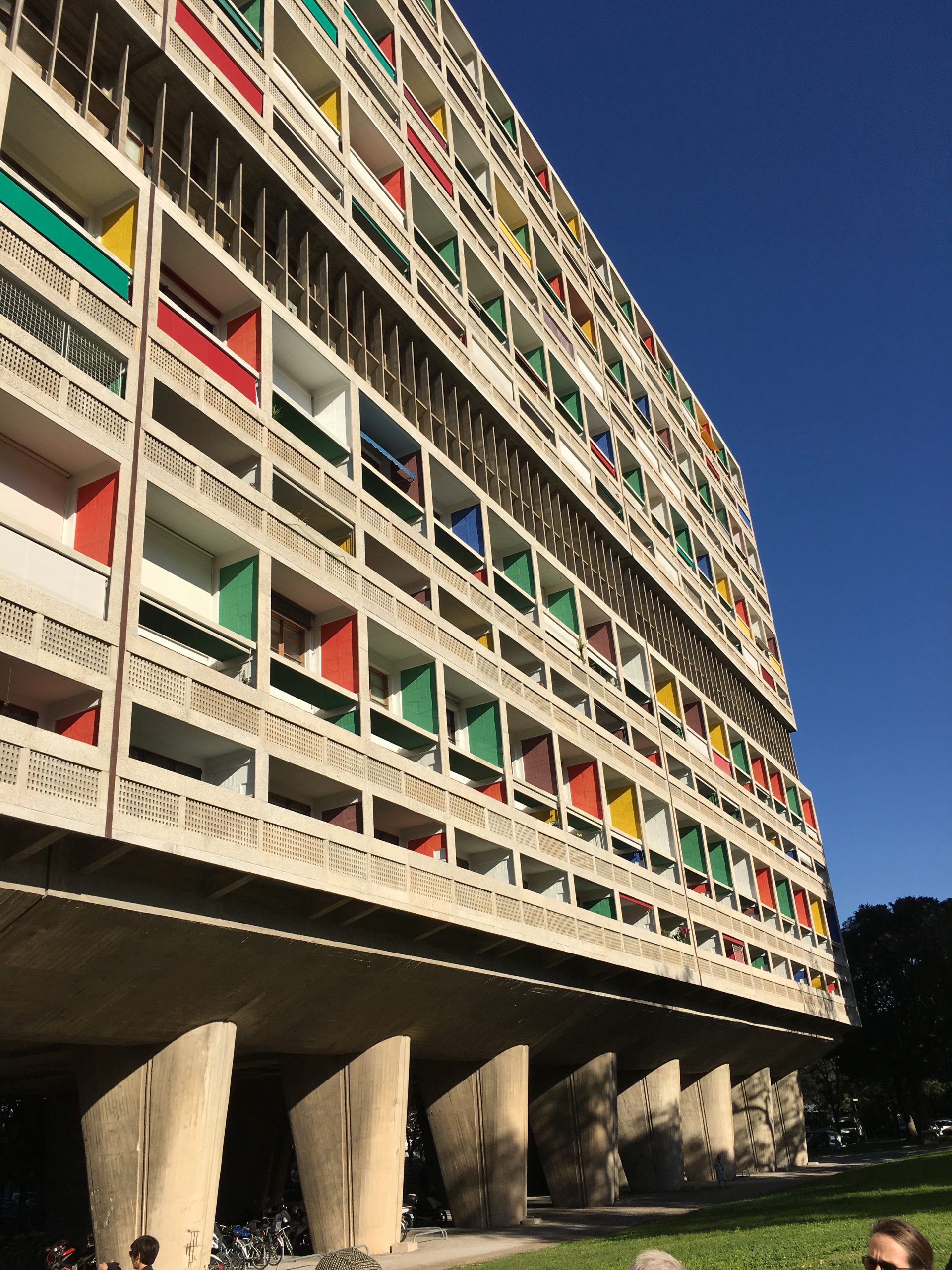 Concrete building with blue, red, green and yellow window frames
