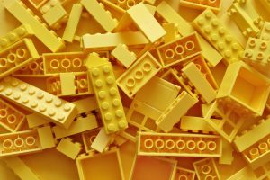 many yellow Lego bricks disordered on top of each other