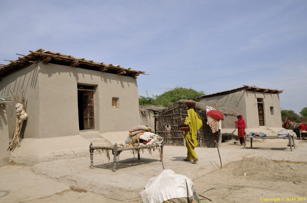 two one-storey mud houses with one door and one window each