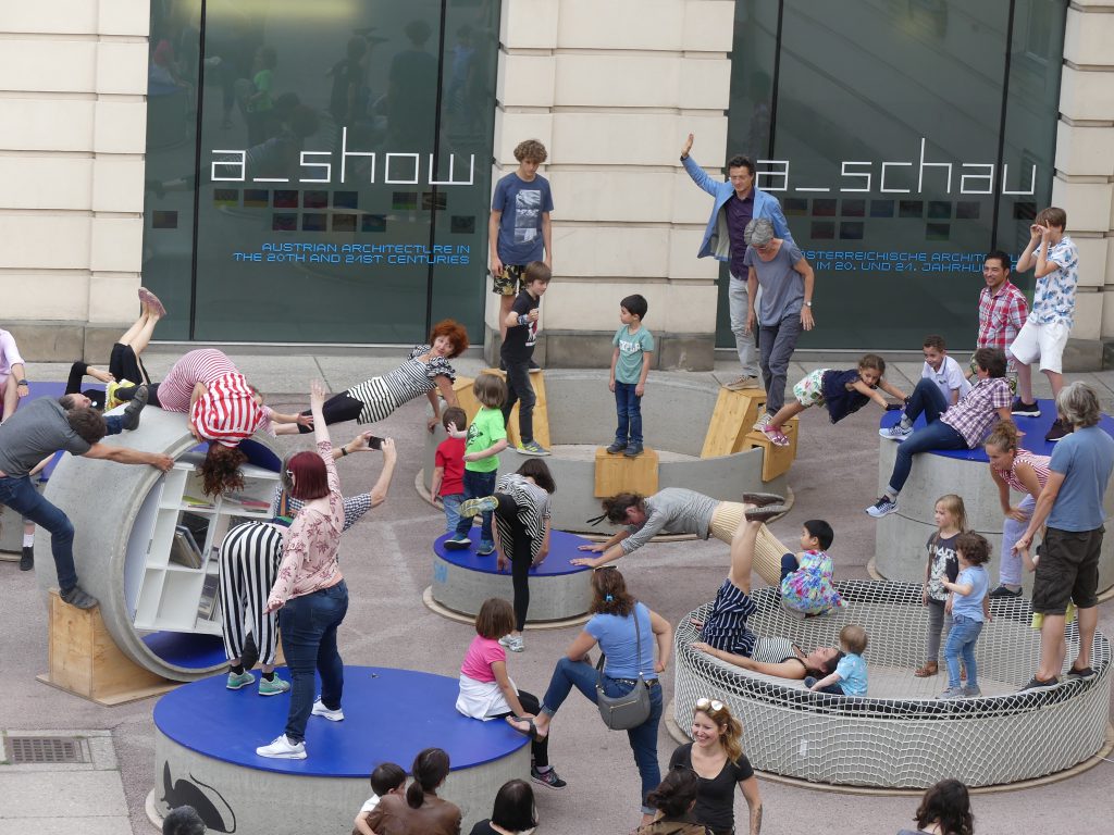 Children and adults gymnastics on concrete rings