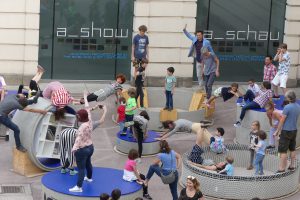 Children and adults gymnastics on concrete rings