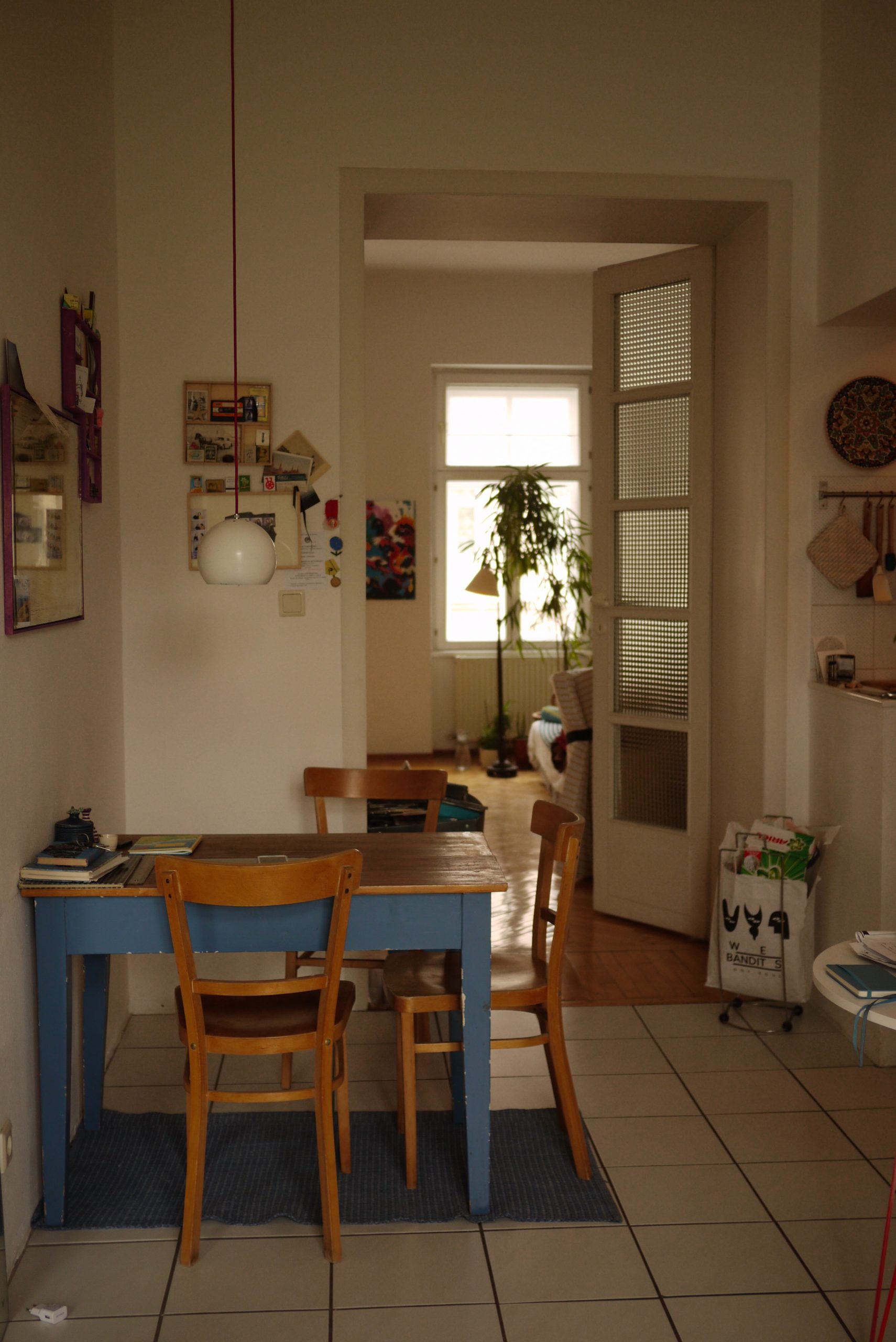 Blue table with three chairs in a kitchen