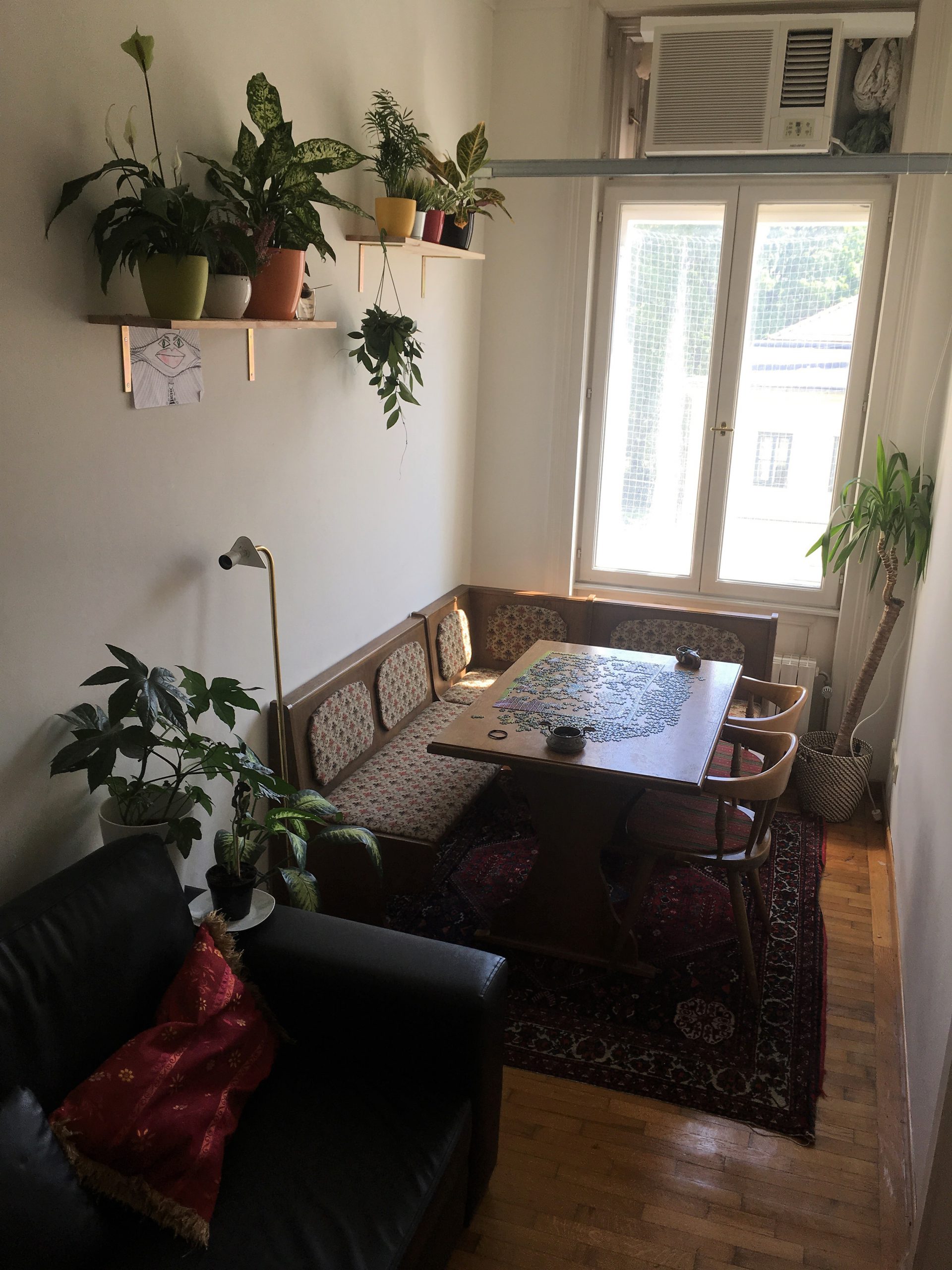 table with plants and flowers on the wall