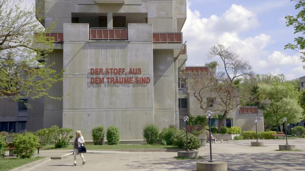 Multi-storey building with concrete facade and lettering