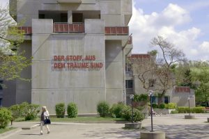 Multi-storey building with concrete facade and lettering