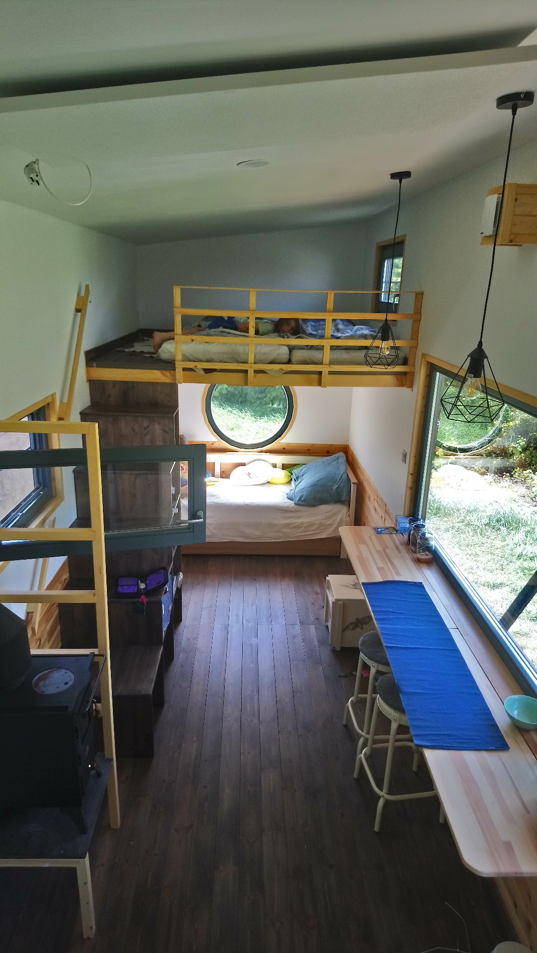 Interior view of a small room with bunk beds and a table