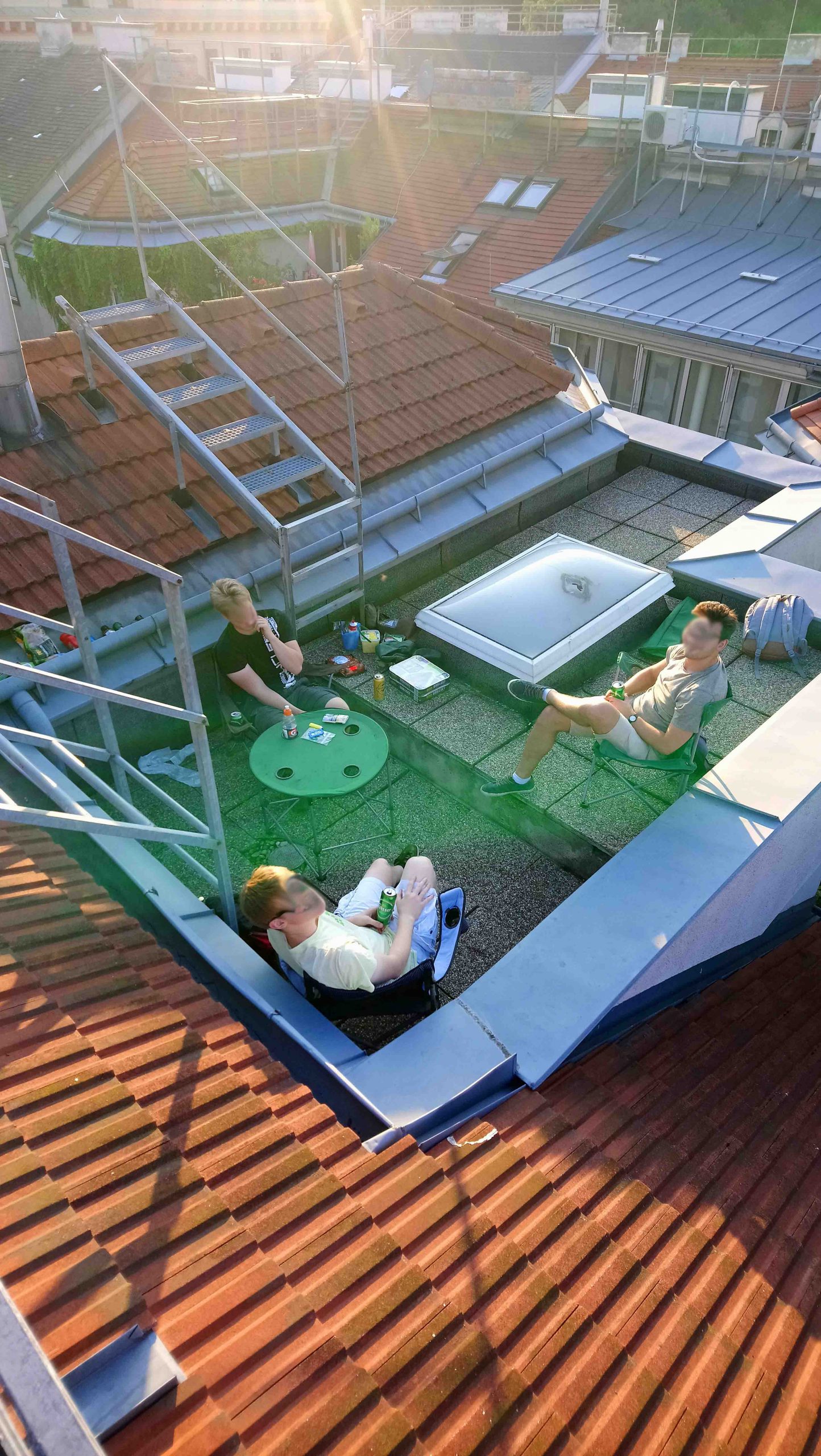 three men on a rooftop terrace