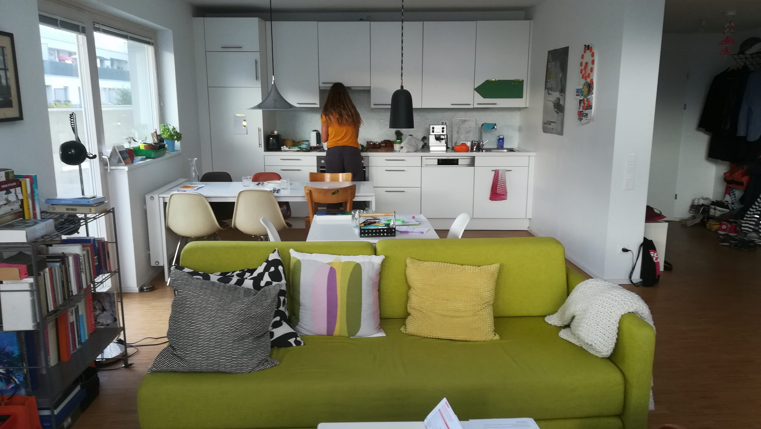 Kitchen and a green couch in the foreground