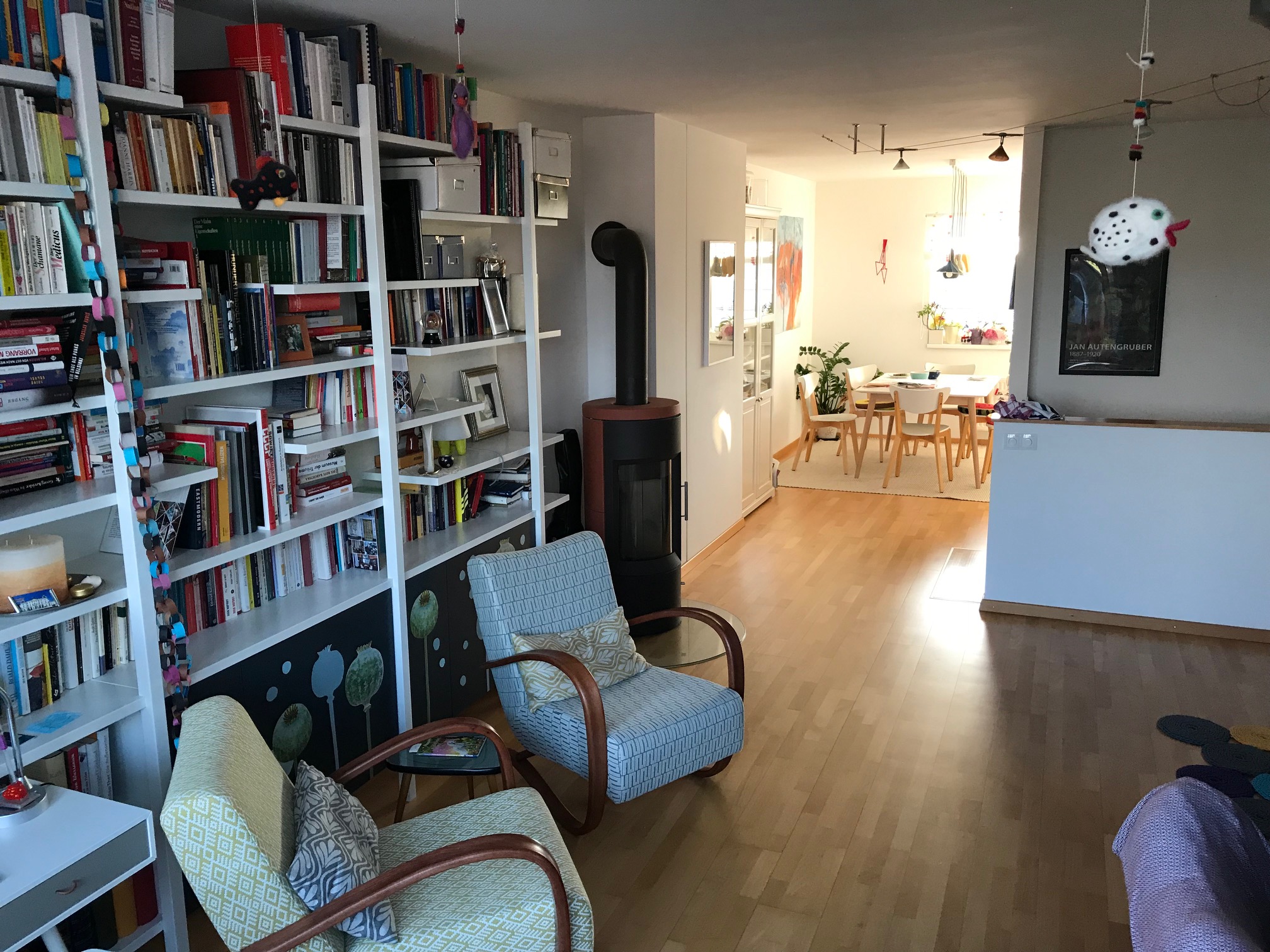 two armchairs in front of a bookcase as high as a wall