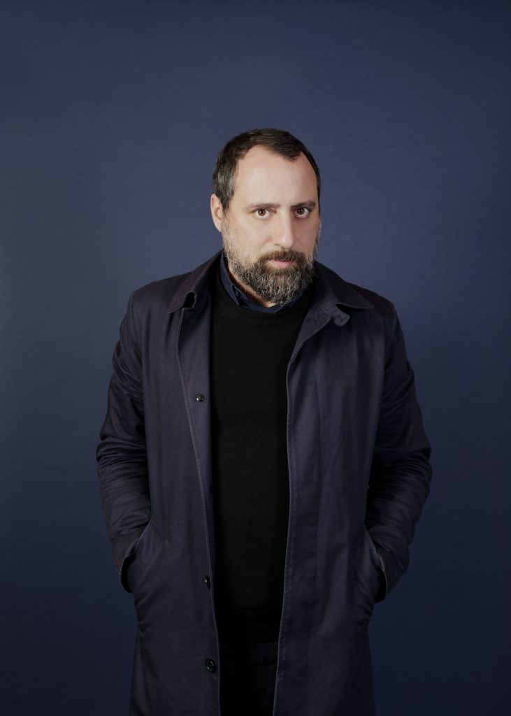 black dressed dark-haired man with beard