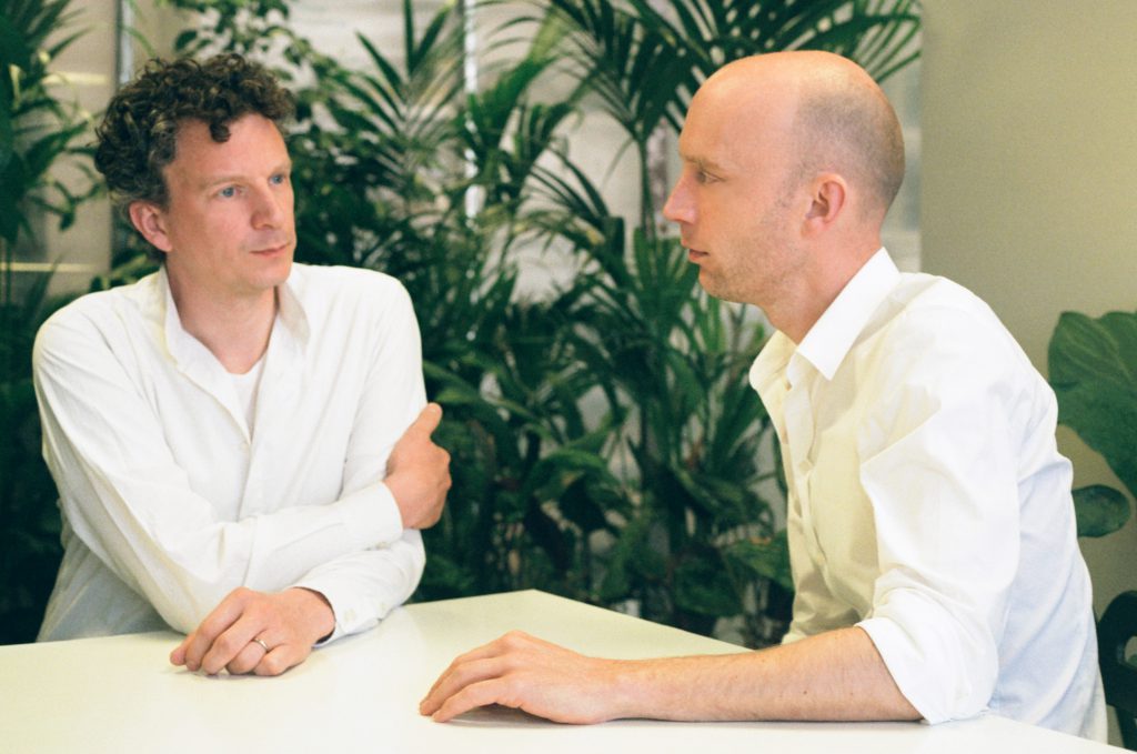 two men sitting at one table