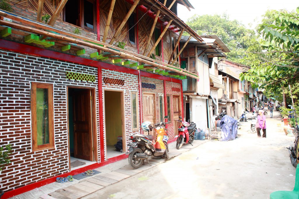 Houses with multicoloured facades, mopeds park in front of them