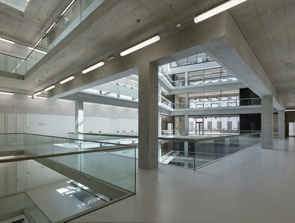 Interior with shaft and galleries made of concrete and glass