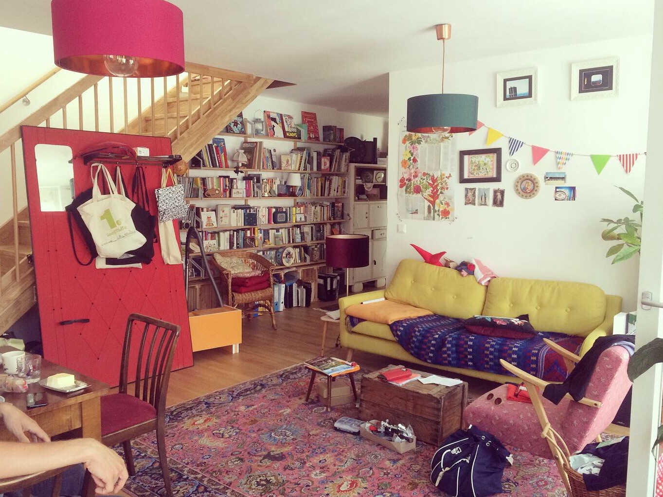 Living room with yellow sofa and bookshelf