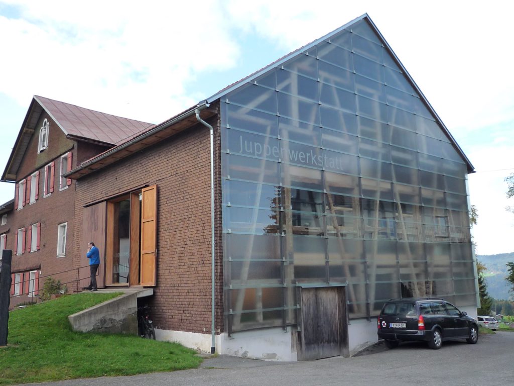 a house with shingle façade on the one hand and glass façade on the other hand