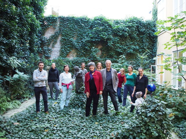 a group of people in an ivy-covered courtyard.