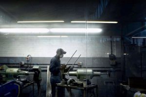 man working in a factory with mask