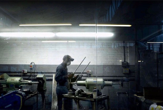 man working in a factory with mask