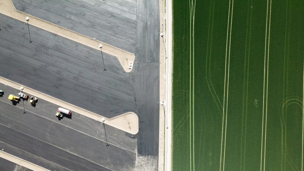 green fields and parking zone from bird's eye view