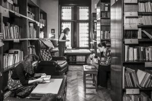 black white photo with 3 women in a library