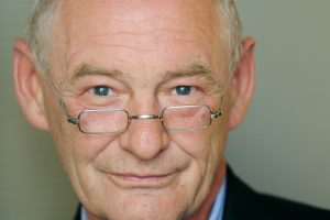 Portrait of man with black jacket and glasses