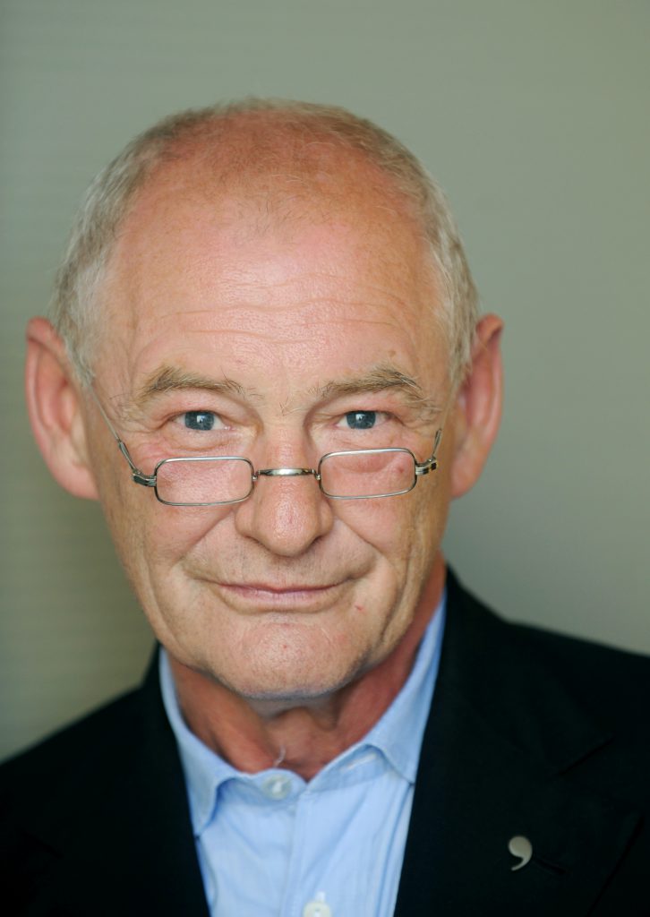 Portrait of man with black jacket and glasses