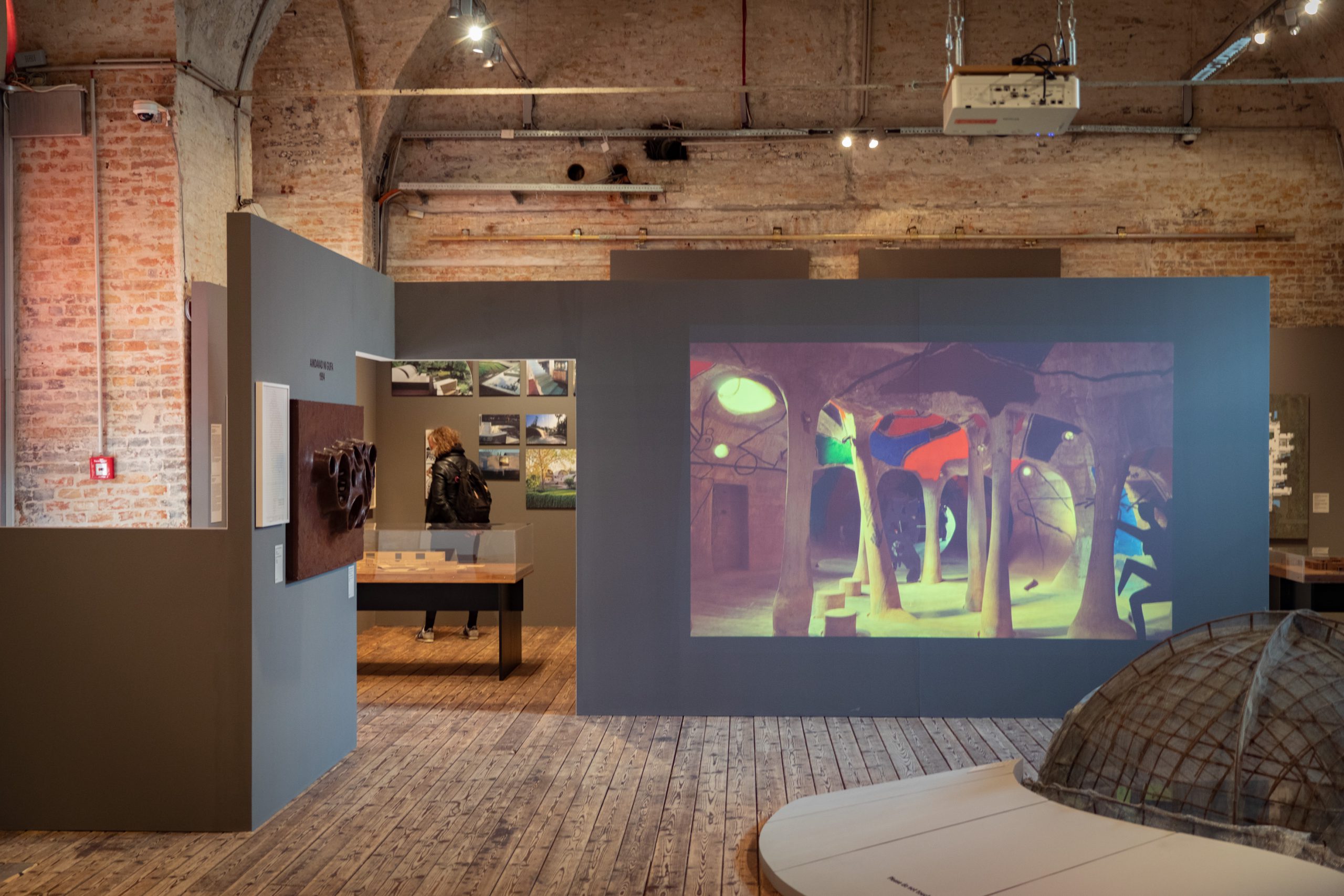 screen with photographs of an underground gallery