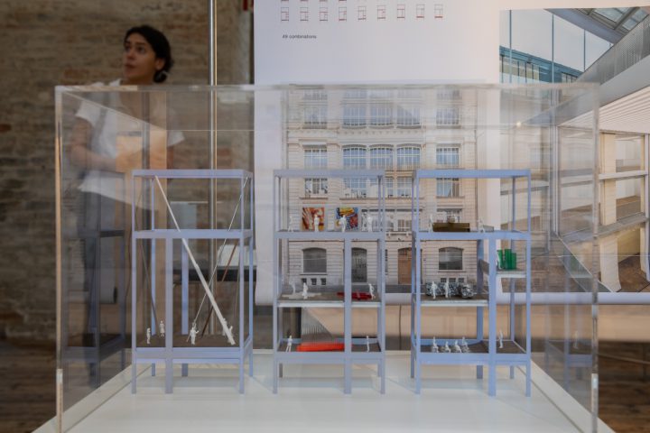 Woman with white T-shirt behind an architectural model