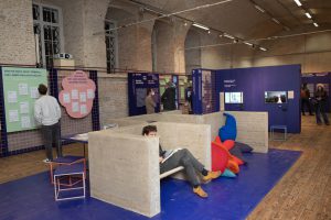 Concrete bunk in an exhibition with blue walls