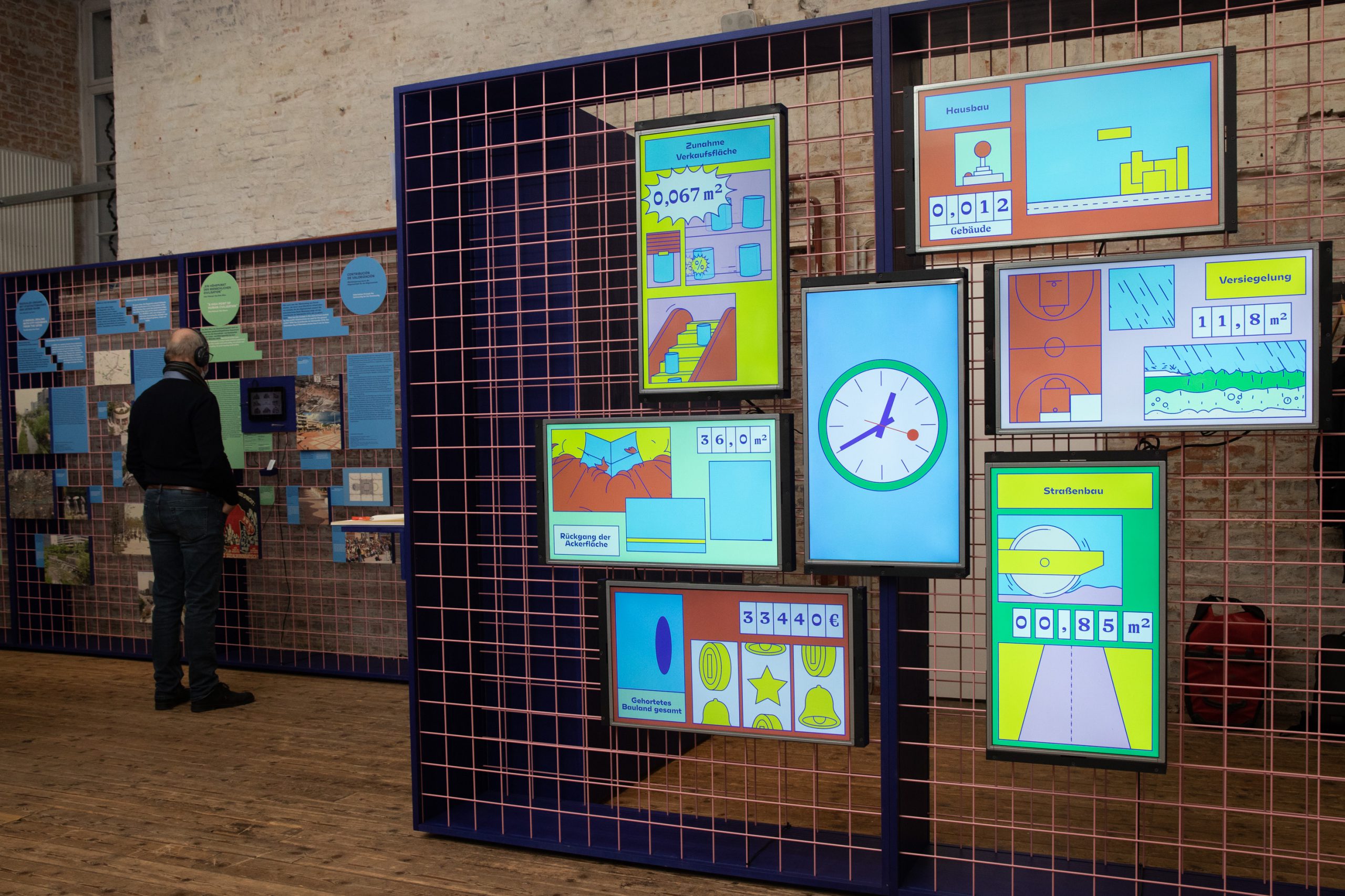 7 colorful screens on a grid wall