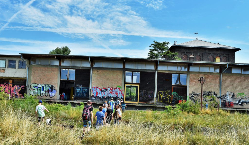 a group of people in front of a building with graffiti