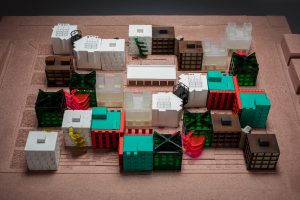 Architectural model with green, white, brown and transparent houses