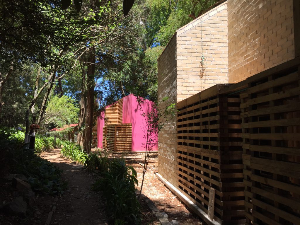 Brick and wood houses with pink coloured walls